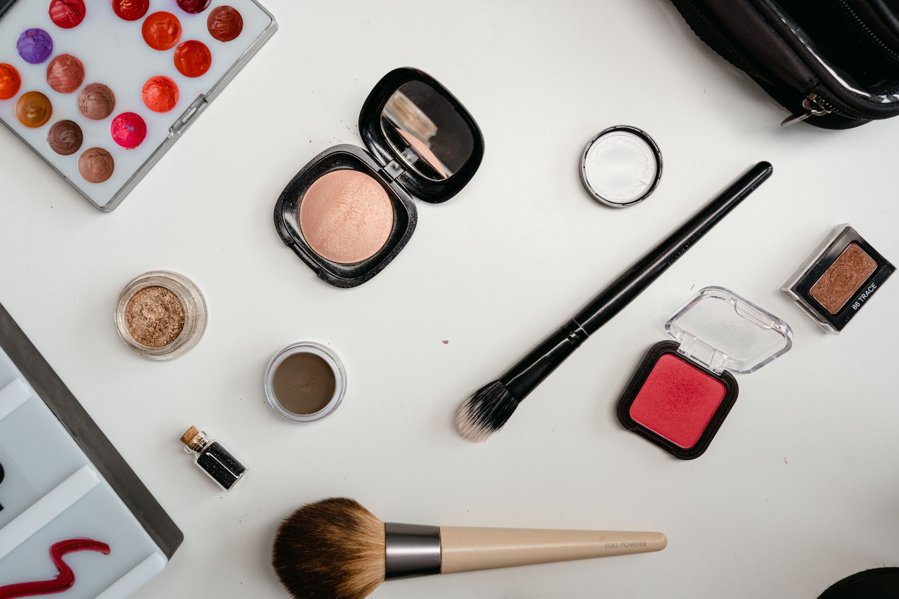 Cosmetic tools and color products arranged on a clean work surface